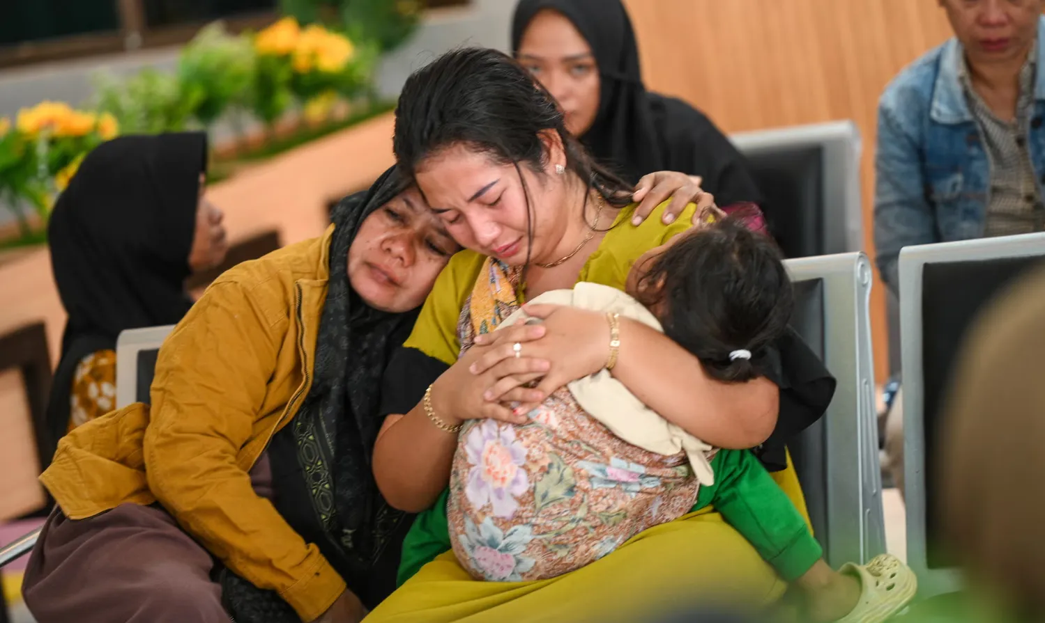 Relatives wait for updates after a ferry sank off the popular Indonesian resort island of Bali