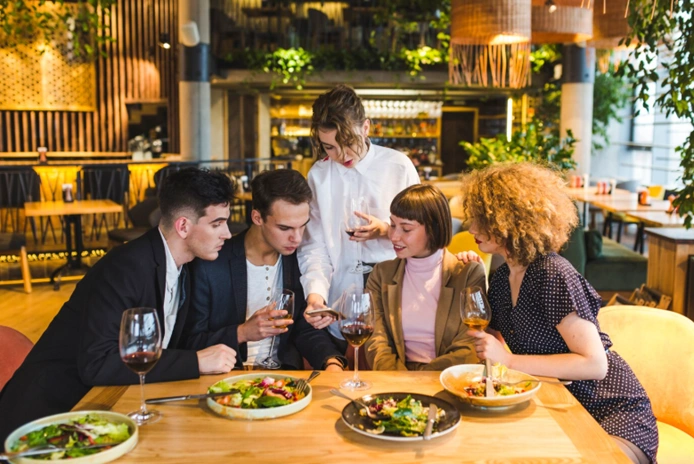 group of diners at a restaurant highlighting rising costs of eating out during public holidays in australia